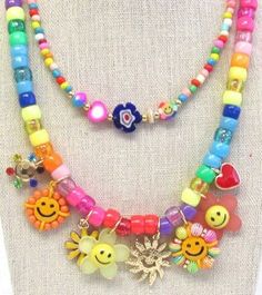 Rainbow beads,  smiley face charms, flowers, sunshine.  and hearts theme multi charm multi layer necklace and gold ball stud earrings set is fun,  happy, and fabulous!!  Size: Length 16 inches on shortest layer the gold tone paper clip chain the necklace has 3 inch extender chain Cheap Multicolor Beaded Charm Necklace, Fun Multicolor Charm Jewelry, Trendy Multicolor Necklace With Flower Charm, Funky Handmade Dangle Jewelry, Whimsical Multicolor Jewelry With Dangling Charms, Whimsical Multicolor Jewelry With Charms, Whimsical Multicolor Charms Jewelry, Trendy Summer Jewelry With Flower Charm, Bohemian Spring Jewelry With Colorful Beads