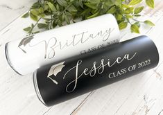 two personalized graduation gifts are sitting on a table