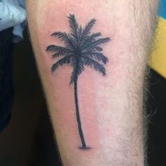 a small palm tree tattoo on the leg