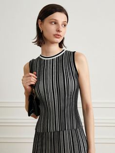 This is yyiam’s sophisticated striped sleeveless knit top allows for a cheerful yet elegant look with its stripe pattern. Thanks to its fabric's elasticity, it offers comfortable wear. It's versatile, suitable for wearing alone or layering with other items.- Ideal for daily wear- Can be paired with various styles of bottoms to create different looks- Its unique design makes it easy to match with any outfit, adding a stylish touch Striped Ribbed Sleeveless Top, Fitted Striped Knit Tank Top, Chic Knit Top With Contrast Stripes, Chic Knit Tops With Contrast Stripes, Chic Striped Fitted Tank Top, Chic Striped Sweater Vest For Spring, Fitted Striped Knit Top, Chic Striped Knit Tops, Fitted Sleeveless Top With Vertical Stripes