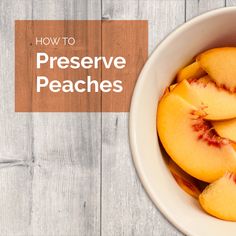 a bowl filled with sliced peaches on top of a wooden table