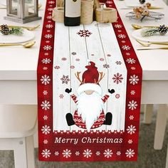 a christmas table runner with a santa clause on it and wine bottles in the background