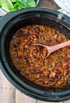 a slow cooker filled with beans and meat