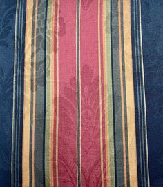 a blue and pink striped fabric with flowers on it