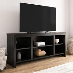 a flat screen tv sitting on top of a wooden entertainment center