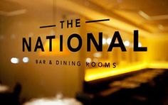 the national bar and dining rooms logo is seen through glass in this restaurant's window