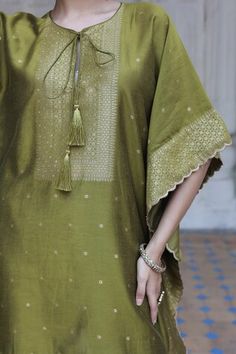 Mehendi green three fourth batwing sleeves kaftan crafted in vegan silk with edelweiss bloom woven detail in gold tone and woven buttis highlights. Paired with a matching straight pant. - Aza Fashions Green Tunic Kaftan For Festive Occasions, Green Tunic Kaftan For Festivals, Festive Green Tunic, Green Festive Tunic, Green Festive Tunic For Eid, Elegant Green Kaftan For Festivals, Elegant Green Festival Kaftan, Green Tunic For Eid, Festive Green Bohemian Tunic