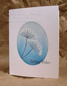 a birthday card with a dandelion in the center on a brown paper background