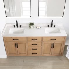 two sinks in a bathroom with mirrors above them