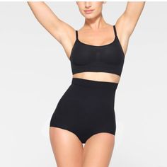 Shape Your Curves And Feel Supported In This Stretchy Shapewear High Waisted Brief With Strong Targeted Compression At The Tummy And Waist, Butt-Shaping Pockets, And A Silicone Interior Underband That Keeps It From Rolling Down. Hits Right Below The Bust And Features A Wider Crotch For Added Coverage And A Cotton Gusset. Underband With Interior Silicone To Prevent Rolling, Mid-Level Compression Along Tummy And Waist, Brief Back With Butt Pockets To Lift And Add Butt Definition, Cotton Gusset 79% Nylon / 22% Spandex Hand Wash Cold, Only Non-Chlorine Bleach When Needed, Line Dry, Cool Iron If Needed, Do Not Dry Clean New Without Tags, Never Worn. Smoke Free Home New To Poshmark? Sign Up Wi Black High Waist Shapewear With Built-in Bra, High Waist Seamless Shapewear For Workout, Black Sculpting Shapewear For Workout, High Waist Shapewear With Built-in Bra For Workout, Stretch Black Shapewear For Workout, Black Stretch Shapewear For Workout, Black Seamless Shapewear Bottoms, Seamless Full Coverage Shapewear For Workout, Black Seamless Shaping Bottoms