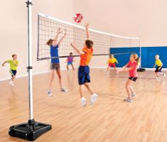 children playing volleyball in an indoor gym