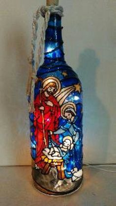 a blue glass bottle with an image of jesus on it