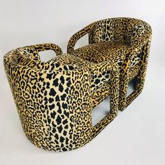 two chairs made out of leopard print material, one is shaped to look like a chair