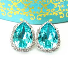 If you're looking for that irresistible Turquoise Blue color then look no beyond, these unique and one-of-a-kind Swarovski teal blue crystals are the perfect choice! The earrings feature 18x13mm Swarovski Turquoise pear stone at the center, surrounded with smaller Swarovski clear rhinestones. The crystals are meticulously handset in Sterling Silver plated brass setting. Lightweight and comfortable to wear! Perfect for brides, bridesmaids, special occasions or just any other day! *AVAILABLE IN MA Elegant Turquoise Teardrop Earrings For Party, Turquoise Wedding Jewelry For Pierced Ears, Elegant Turquoise Earrings For Wedding, Elegant Turquoise Wedding Earrings, Turquoise Earrings For Wedding, Elegant Turquoise Bridal Earrings For Wedding, Turquoise Blue Color, Fancy Stones, Turquoise Crystal