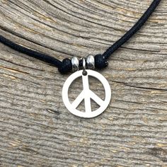 "Peace Sign Choker Pendant Peace Sign charm Charm is 17.5 mm approximately 3/4 inch, Non-Tarnish Stainless Steel Charm, beads, clasp, extender chain Black Natural Cotton cord, thick. Cord measure 14\" with 2\" extender total of 14\"- 16\" adjustable- custom sizes available Need Shorter or Longer cord? We have optional lengths available, message us we can customize for you Matching Earrings and Bracelets available M O R E ∙ I N S P I R E D ∙ D E S I G N S www.etsy.com/shop/BeInspiredUP ⓒ All Desi Adjustable Charm Necklace With Round Pendant, Minimalist Adjustable Charm Necklace With Lobster Clasp, Adjustable Round Charm Necklace Nickel Free, Adjustable Nickel-free Round Charm Necklace, Adjustable Round Charm Necklace With Lobster Clasp, Adjustable Symbolic Metal Necklace, Symbolic Adjustable Metal Necklace, Adjustable Silver Choker With Lobster Clasp, Stainless Steel Adjustable Choker