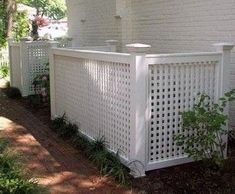 a white privacy fence in front of a house