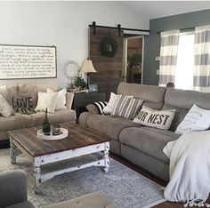 a living room with couches, chairs and a coffee table in it's center