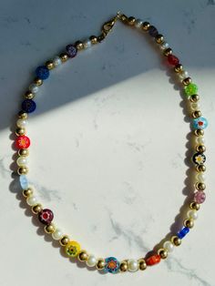 Millefiori Bead Necklace with Pearls, Handmade Rainbow multicolored Harry styles necklace choker, Gift for Her MATERIAL - Made of glass pearls and glass millefiori beads - Nickel and lead free NECKLACE LENGTH - 15.3 Inches ( 39 cm) If you want shorter (choker style 38-39 cm ), then please let me know. CLOSURE: Lobster claw CHAIN STYLE: Bead GIFT BOX - If you want a gift box, just let me know. PRODUCTION TIME -1-2 business days Necklace is handmade by me. CARE INSTRUCTIONS Avoid humidity, please Multicolor Letter Beads Choker With Round Beads, Multicolor Choker With Round Letter Beads, Multicolor Letter Beads Choker, Gift Multicolor Round Beads Choker, Gift Multicolor Choker With Round Beads, Gold Necklaces With Letter Beads For Festivals, Multicolor Spacer Beads Choker Necklace, Multicolor Choker Necklace With Spacer Beads, Colorful Pearl Beaded Choker Necklace