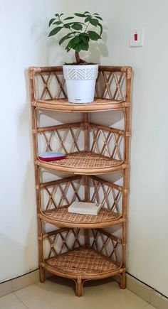 a bamboo shelf with a potted plant on top