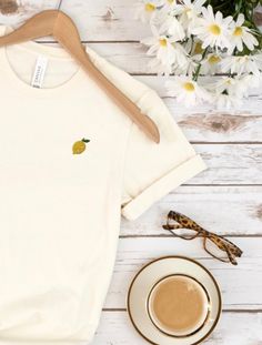 Introducing our zesty and fun embroidered lemon t-shirt! Made from high-quality, lightweight cotton material, this shirt is perfect for a casual summer day or adding some brightness to your wardrobe. Featuring a beautifully detailed and vibrant embroidered lemon design on the front, this t-shirt is a refreshing addition to any outfit. The classic crew neck and short sleeves provide a comfortable and relaxed fit while the soft and breathable cotton fabric keeps you cool on warm weather days. This Stitch Tshirt, Lemon Design, Fruit Shirt, Juicy Fruit, Cute Fruit, Reduce Waste, Dyeing Process, Graphic Tees Women, Everyday Style