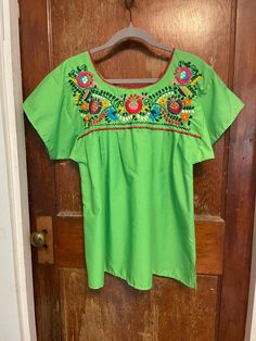 Gorgeous vibrant lime green embroidered blouse. Beautiful floral embroidery.  In great condition. Some loose threads along the hems, but nothing that impacts the structure.  No tags, but feels like cotton.  All measurements are listed in the final picture. Spring Bohemian Crew Neck Blouse, Green Embroidered Long Sleeve Tops, Green Long Sleeve Top With Floral Embroidery, Green Embroidered Crew Neck Blouse, Spring Embroidered Green Blouse, Green Long Sleeve Tops With Embroidered Neckline, Green Long Sleeve Top With Embroidered Neckline, Embroidered Crew Neck Blouse For Summer, Green Blouse With Embroidered Neckline