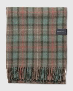 a green and brown plaid blanket on a white background