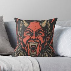 an evil demon with horns and fangs on his face throw pillow