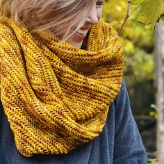 a woman wearing a yellow knitted scarf