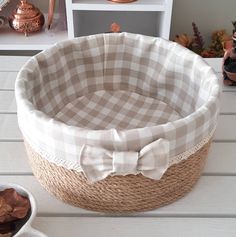 a basket with a bow on it sitting on top of a table next to other items