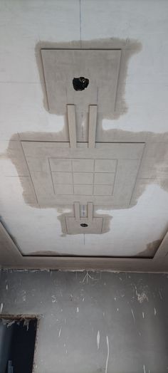 the ceiling is being painted white and there are holes in the plaster that have been removed