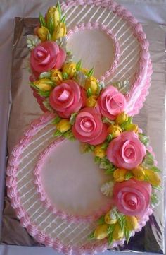 a cake decorated with flowers and the number eight