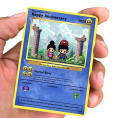 a hand holding up a card with two people on it