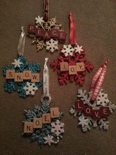 christmas ornaments made from scrabbles on the floor with words that spell out peace and joy