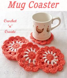 three crocheted coasters sitting on top of a table next to a coffee cup