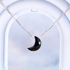 A subtly beautiful necklace for the minimalist who appreciates healing gemstones. This handmade pendant necklace features a carved black onyx crescent moon suspended from a delicate sterling silver chain - simple yet striking. Black onyx, a calming stone, lends an air of serenity when worn close to the heart. The sterling silver chain is cool and lightweight, ideal for everyday wear that doesn't demand attention yet flatters with understated elegance. An effortlessly chic accessory for the modern mystic. Materials: Black Onyx, 925 sterling silverChain length: 18 in adjustable any length shorter Jewelry Care: See more information about how to care for your jewelry here. Shipping Policy: Orders will be shipped within 1-3 business days. Economy shipping will take 7-14 days to arrive and stand Elegant Black Necklace With Moon Charm, Black Moon Phase Round Pendant Necklace, Elegant Black Crescent Necklace, Black Moon Phase Round Pendant Jewelry, Elegant Black Moon Phase Necklace, Black Half Moon Jewelry With Moon Phase Design, Black Half Moon Jewelry With Moon Phase Detail, Black Sterling Silver Moon Phase Necklace, Minimalist Moon Shaped Gemstone Necklace