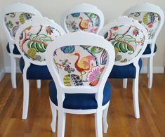 several white chairs with colorful designs on them