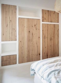 a bedroom with wood paneling and white walls