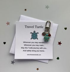 a card with a keychain attached to it that says, travel turtle wherever you may roam