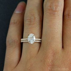 a woman's hand with a ring on it and a diamond in the middle