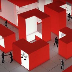 several people are standing in front of red and white cubes that appear to be interlocked