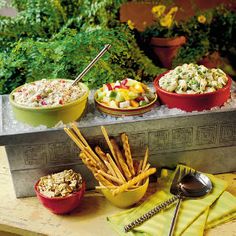 several bowls and plates of food on a table