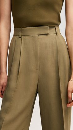 Our slouchy Pleated Trouser is a timeless piece that finds balance in touting both a wide-leg and a slim fit. The pant borrows from traditional suiting with a curtained waistband — which sits at the natural waistline for a flattering appearance — alongside pleated detailing. Timeless Semi-formal Wide Leg Bottoms, Timeless Wide Leg Pants For Workwear In Spring, Timeless Wide Leg Tailored Pants, Timeless Tailored Wide Leg Pants, Timeless Wide-leg Pants For Tailoring, Timeless Wide-leg Tailored Pants, Classic Wide-leg Pantsuit, Classic Wide Leg Pantsuit For Tailoring, Timeless Straight Leg Spring Bottoms