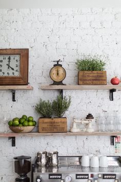 some shelves with various items on them and a clock mounted to the wall behind them