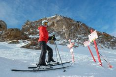 a man riding skis on top of a snow covered slope