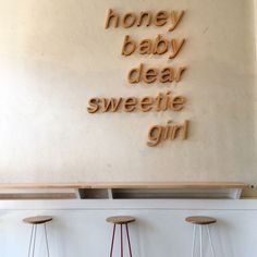 three stools in front of a sign that says honey baby dear sweetie girl