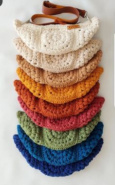 a stack of crocheted purses sitting on top of each other