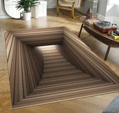 a living room filled with furniture and a rug on top of a hard wood floor