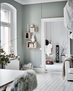 a living room filled with furniture and lots of white stuff on the wall next to a window