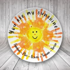 a painted plate with the words we are my sunshine on it