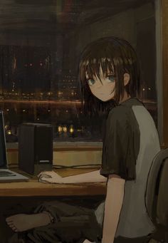 a person sitting at a desk in front of a laptop computer with the city lights behind them